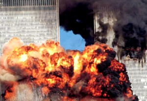 Colour photograph showing the two World Trade Center Towers immediately after the impact of the second plane. At a fundamental level, this was a very serious 'real' fire incident ... which was extensively, and very thoroughly, investigated by the U.S. National Institute of Standards & Technology (NIST) ... and resulted in the important 2005 & 2008 NIST Recommendations. Click to enlarge.