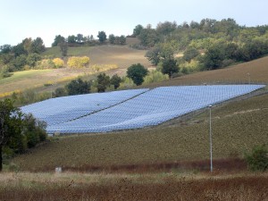 Colour photograph showing a Photovoltaic Field near the road from Amandola to Macerata, in Le Marche ... where good agricultural land has been 'planted' with photovoltaic panels. Photograph by CJ Walsh. 2011-10-29. Click to enlarge.