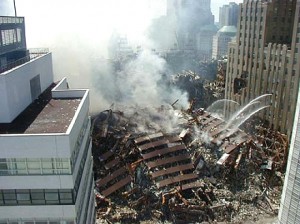 Colour photograph showing World Trade Center Building No. 7 in ruins after 9-11 in New York City ... when Fire-Induced Progressive Damage led to Disproportionate Damage, and finally to total building failure ... a Collapse Level Event (CLE). Click to enlarge.
